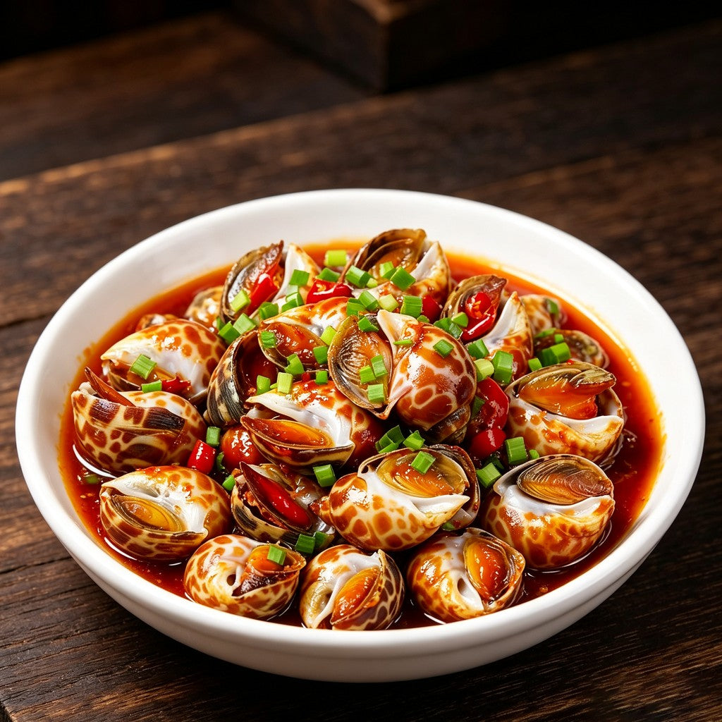 Spicy snails in red chilli sauce with spring onion in a white bowl
