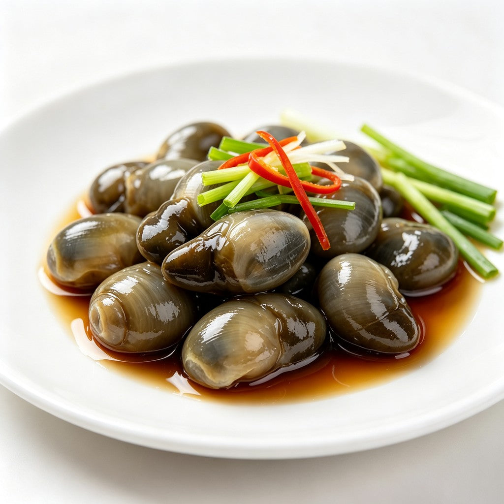 Glossy marinated shellfish in dark savoury sauce with chilli and spring onion